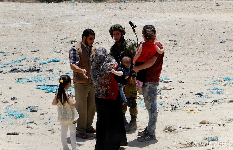 Israeli soldiers stop Palestinians at the entrance of Yatta near the West Bank city of Hebron June 9, 2016. The Israeli army entered the village in search for clues leading to an attack the previous night in the Israeli...