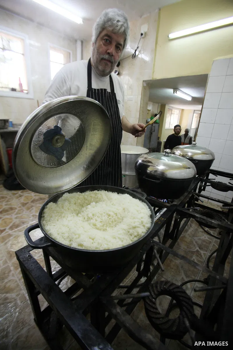 A Palestinian man prepares food for the poor Palestinians from an Islamic charity "Tekkia" in the West Bank city of Nablus on the holy month of Ramadan on June 09, 2016. Ramadan is sacred to Muslims because it is during...