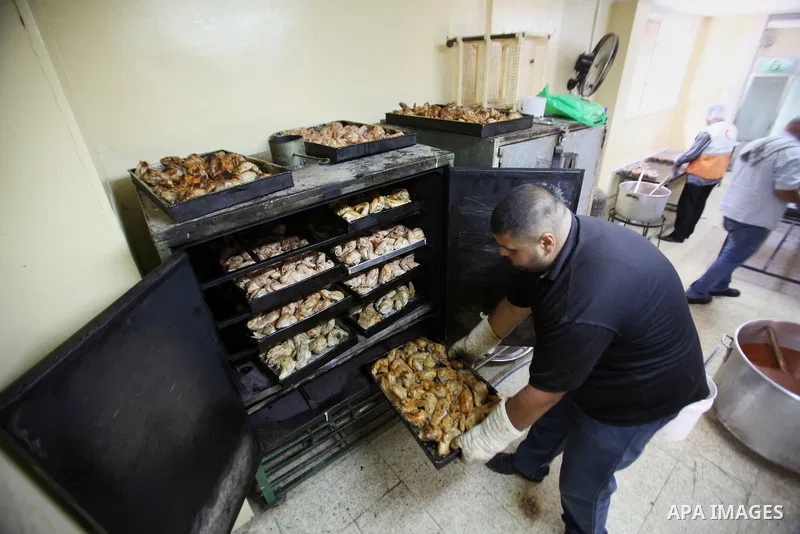 A Palestinian man prepares food for the poor Palestinians from an Islamic charity "Tekkia" in the West Bank city of Nablus on the holy month of Ramadan on June 09, 2016. Ramadan is sacred to Muslims because it is during...