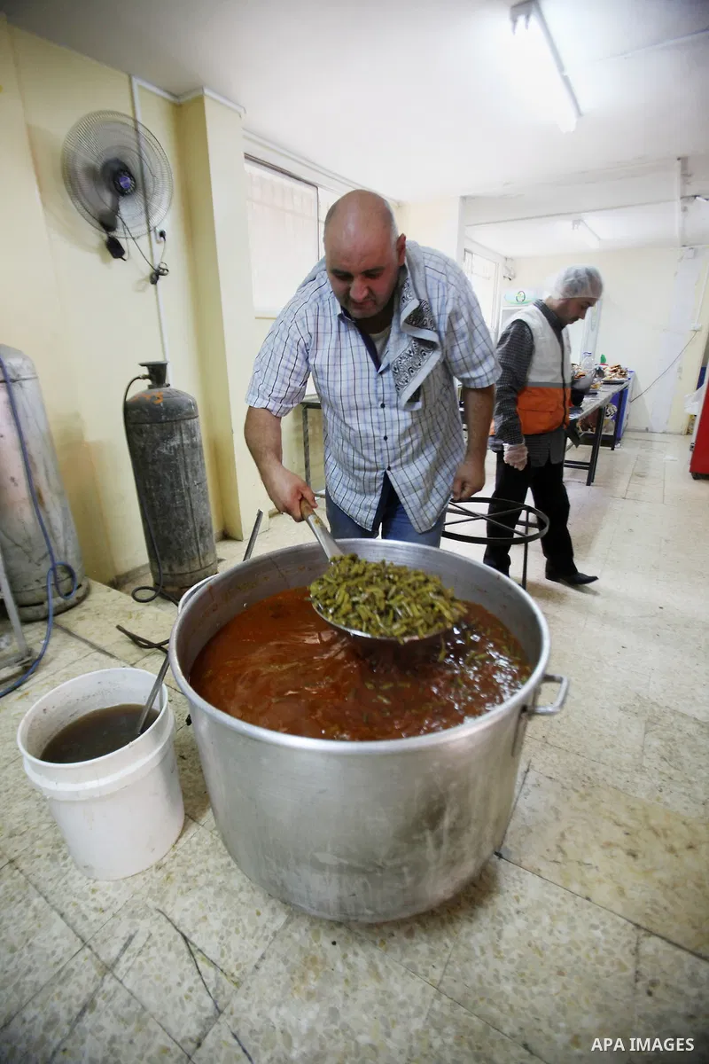 A Palestinian man prepares food for the poor Palestinians from an Islamic charity "Tekkia" in the West Bank city of Nablus on the holy month of Ramadan on June 09, 2016. Ramadan is sacred to Muslims because it is during...
