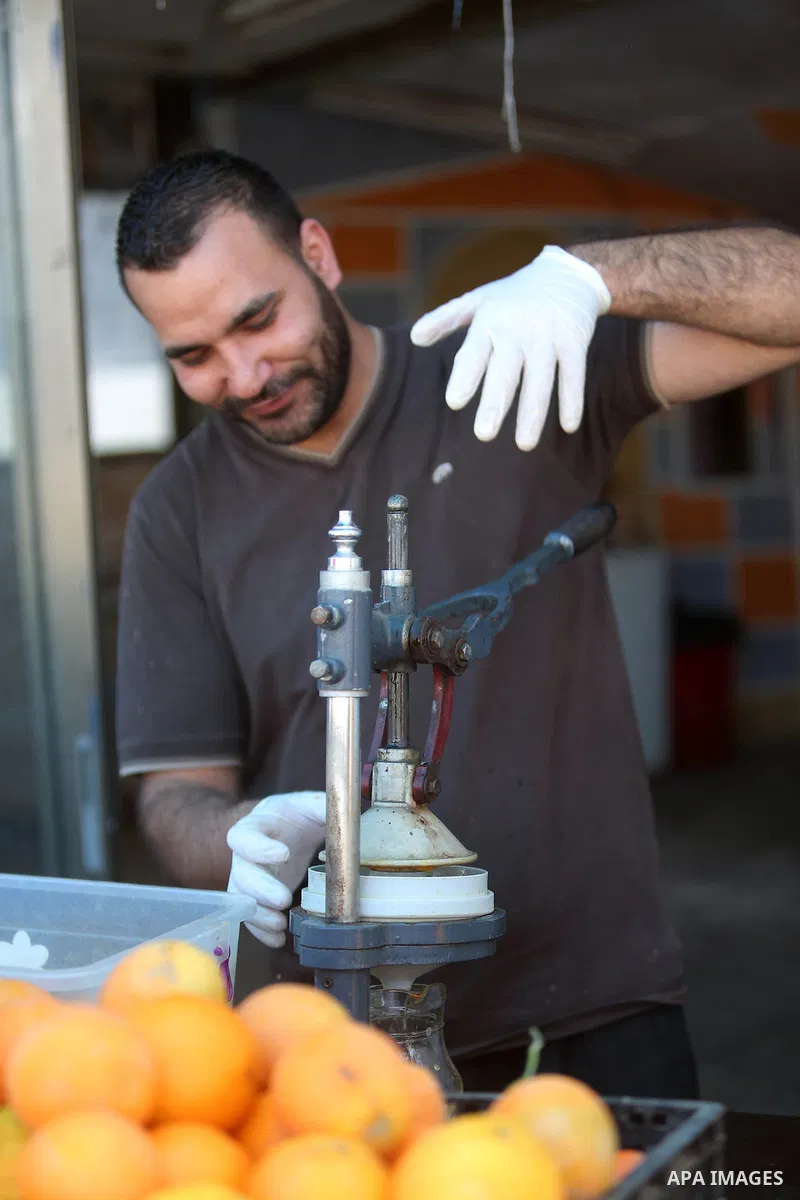 A Palestinian vendor prepares orange juice on the holy month of Ramadan at a market in the West bank city of Ramallah, on June 09, 2016. Ramadan is sacred to Muslims because it is during that month that tradition says th...