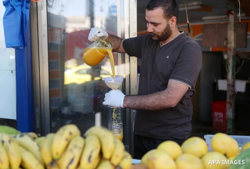 A Palestinian vendor prepares orange juice on the holy month of Ramadan at a market in the West bank city of Ramallah, on June 09, 2016. Ramadan is sacred to Muslims because it is during that month that tradition says th...
