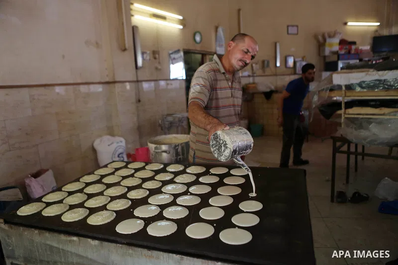 A Palestinian vendor prepares traditional pancakes known as ''Qatayef'' on the holy month of Ramadan at a market in the West bank city of Ramallah, on June 09, 2016. Ramadan is sacred to Muslims because it is during that...