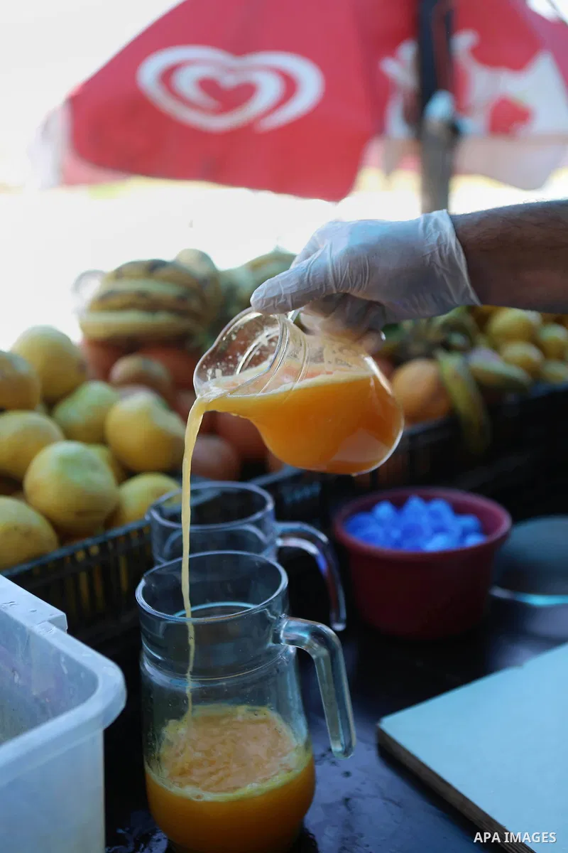A Palestinian vendor prepares orange juice on the holy month of Ramadan at a market in the West bank city of Ramallah, on June 09, 2016. Ramadan is sacred to Muslims because it is during that month that tradition says th...