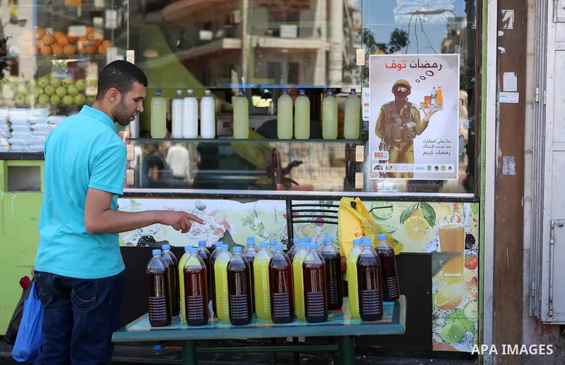 A Palestinian vendor sells juice at a market on the holy month of Ramadan in the West bank city of Ramallah, on June 09, 2016. Ramadan is sacred to Muslims because it is during that month that tradition says the Koran wa...