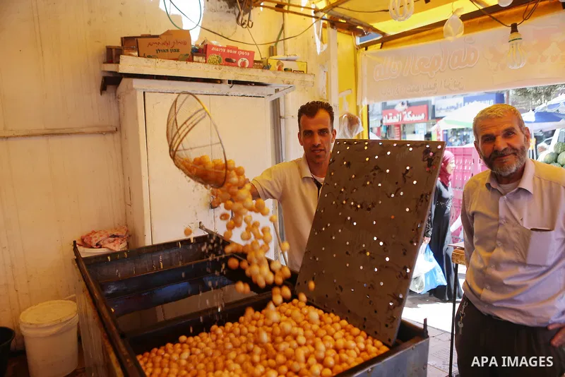 A Palestinian vendor prepares sweets on the holy month of Ramadan at a market in the West bank city of Ramallah, on June 09, 2016. Ramadan is sacred to Muslims because it is during that month that tradition says the Kora...