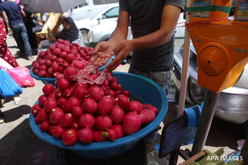 A Palestinian vendor sells fruits at a market on the holy month of Ramadan in the West bank city of Ramallah, on June 09, 2016. Ramadan is sacred to Muslims because it is during that month that tradition says the Koran w...