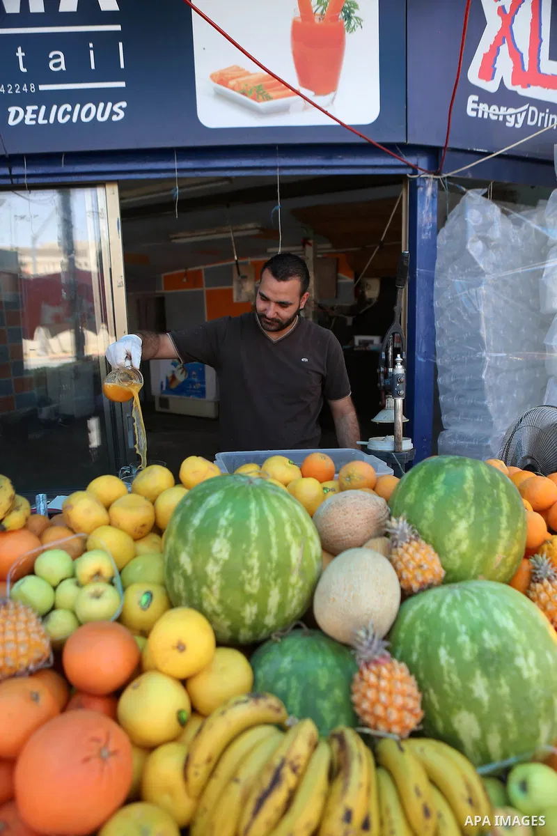 A Palestinian vendor prepares orange juice on the holy month of Ramadan at a market in the West bank city of Ramallah, on June 09, 2016. Ramadan is sacred to Muslims because it is during that month that tradition says th...