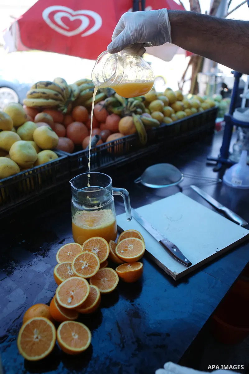 A Palestinian vendor prepares orange juice on the holy month of Ramadan at a market in the West bank city of Ramallah, on June 09, 2016. Ramadan is sacred to Muslims because it is during that month that tradition says th...