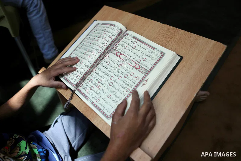 Palestinian Muslim children read the holy Koran, Islam's holy book at Tameem al-Dari mosque on the holy month of Ramadan in the West bank city of Ramallah, on June 09, 2016. Ramadan is sacred to Muslims because it is dur...