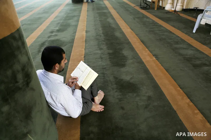 A Palestinian Muslim reads the holy Koran, Islam's holy book at Tameem al-Dari mosque on the holy month of Ramadan in the West bank city of Ramallah, on June 09, 2016. Ramadan is sacred to Muslims because it is during th...
