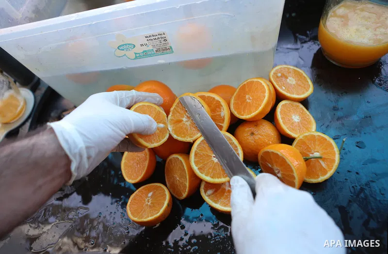 A Palestinian vendor prepares orange juice on the holy month of Ramadan at a market in the West bank city of Ramallah, on June 09, 2016. Ramadan is sacred to Muslims because it is during that month that tradition says th...