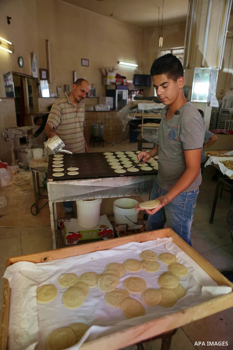 A Palestinian vendor prepares traditional pancakes known as ''Qatayef'' on the holy month of Ramadan at a market in the West bank city of Ramallah, on June 09, 2016. Ramadan is sacred to Muslims because it is during that...