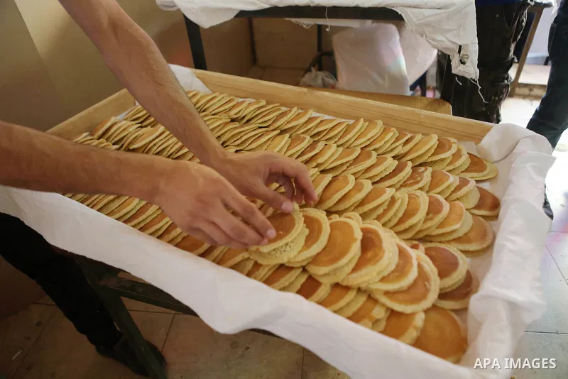 A Palestinian vendor prepares traditional pancakes known as ''Qatayef'' on the holy month of Ramadan at a market in the West bank city of Ramallah, on June 09, 2016. Ramadan is sacred to Muslims because it is during that...