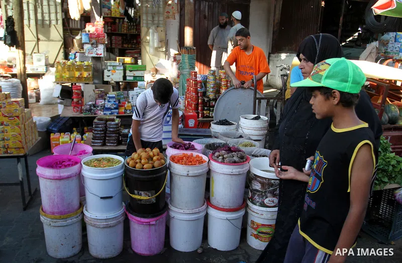A Palestinian man sells pickles at a market during the Muslim holy fasting month of Ramadan in Rafah in the southern Gaza strip, on June 9, 2016. Photo by Abed Rahim Khatib