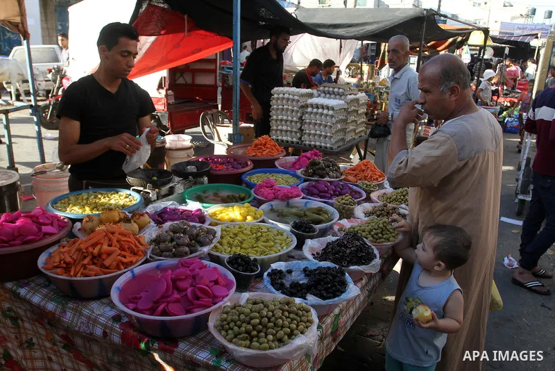 A Palestinian man sells pickles at a market during the Muslim holy fasting month of Ramadan in Rafah in the southern Gaza strip, on June 9, 2016. Photo by Abed Rahim Khatib