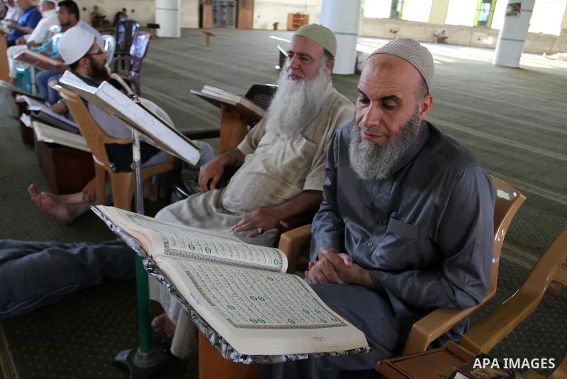 Palestinian Muslims read the holy Koran, Islam's holy book, at a Mosque during the Muslim holy fasting month of Ramadan in Rafah in the southern Gaza strip, on June 9, 2016. Photo by Abed Rahim Khatib