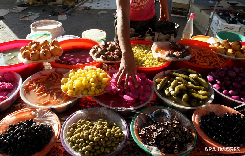 A Palestinian man sells pickles at a market during the Muslim holy fasting month of Ramadan in Rafah in the southern Gaza strip, on June 9, 2016. Photo by Abed Rahim Khatib