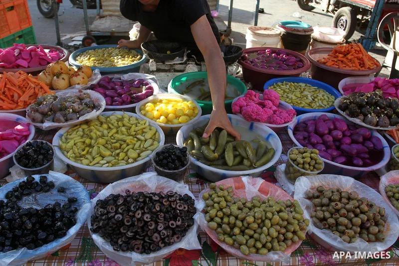 A Palestinian man sells pickles at a market during the Muslim holy fasting month of Ramadan in Rafah in the southern Gaza strip, on June 9, 2016. Photo by Abed Rahim Khatib