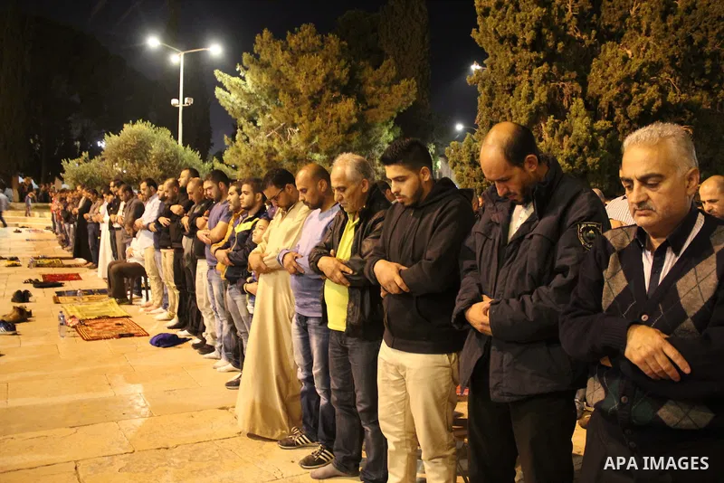 Palestinian Muslim worshipers perform "Taraweeh", nightly prayer of the month of Ramadan, in front of the Dome of the Rock mosque, in Jerusalem's old city on June 9, 2016. Ramadan is sacred to Muslims because it is durin...