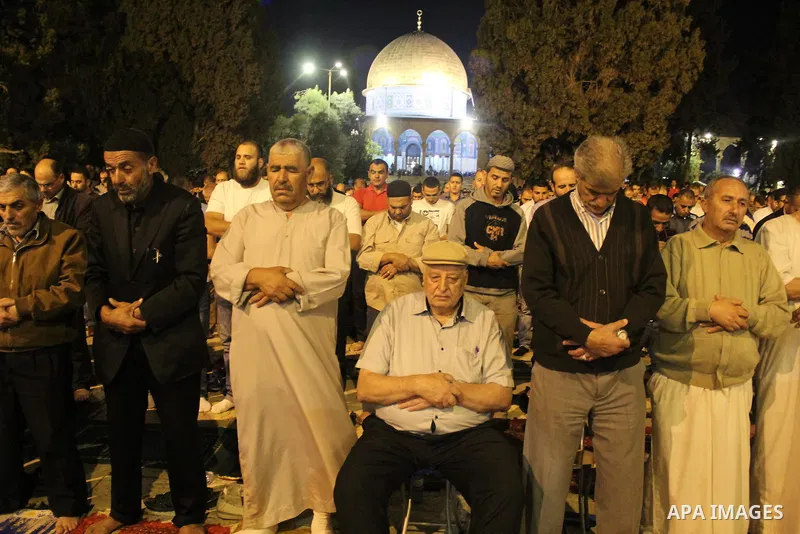 Palestinian Muslim worshipers perform "Taraweeh", nightly prayer of the month of Ramadan, in front of the Dome of the Rock mosque, in Jerusalem's old city on June 9, 2016. Ramadan is sacred to Muslims because it is durin...