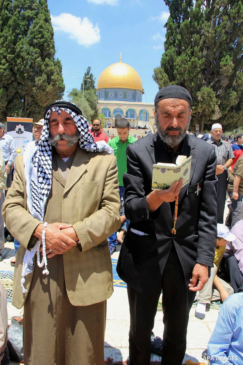 Palestinians pray in front of the Dome of the Rock at Jerusalem's Al-Asqa mosque compound during the first Friday prayers of the holy Muslim fasting month of Ramadan on June 10, 2016. Praying at the site, the third-holie...