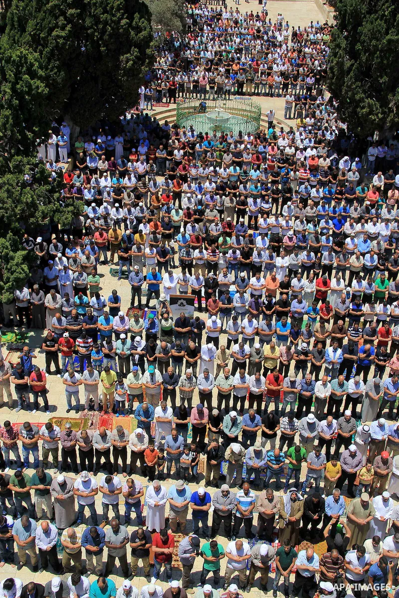 Palestinians pray in front of the Dome of the Rock at Jerusalem's Al-Asqa mosque compound during the first Friday prayers of the holy Muslim fasting month of Ramadan on June 10, 2016. Praying at the site, the third-holie...