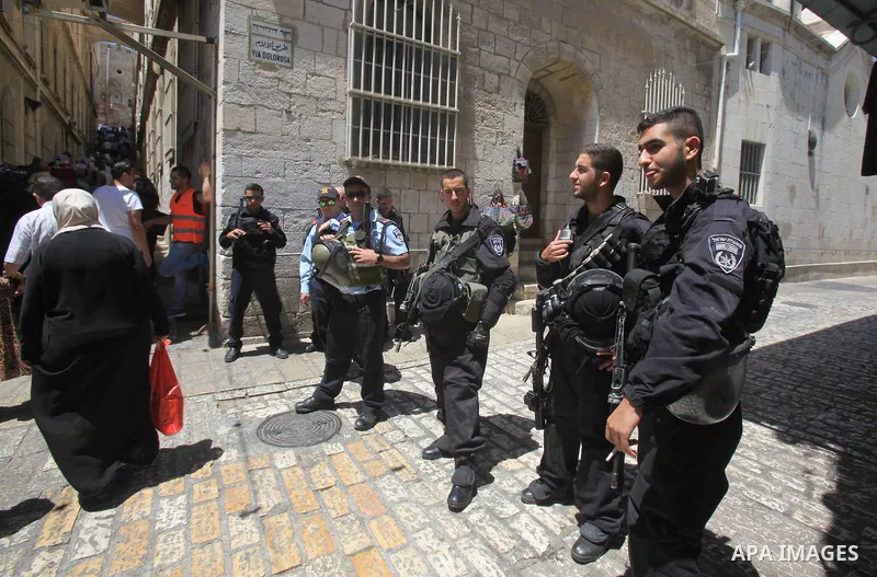 Israeli border police stand guard while Palestinians pray in at Jerusalem's Al-Asqa mosque compound during the first Friday prayers of the holy Muslim fasting month of Ramadan on June 10, 2016. Praying at the site, the t...