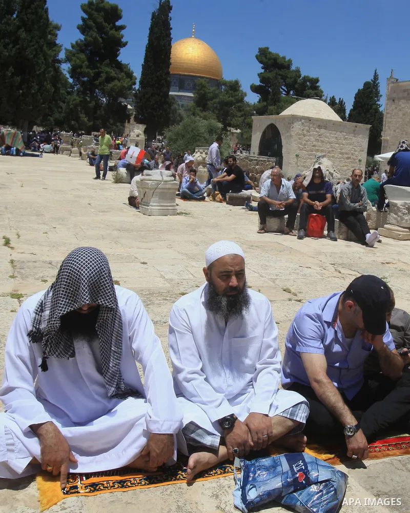 Palestinians pray in front of the Dome of the Rock at Jerusalem's Al-Asqa mosque compound during the first Friday prayers of the holy Muslim fasting month of Ramadan on June 10, 2016. Praying at the site, the third-holie...