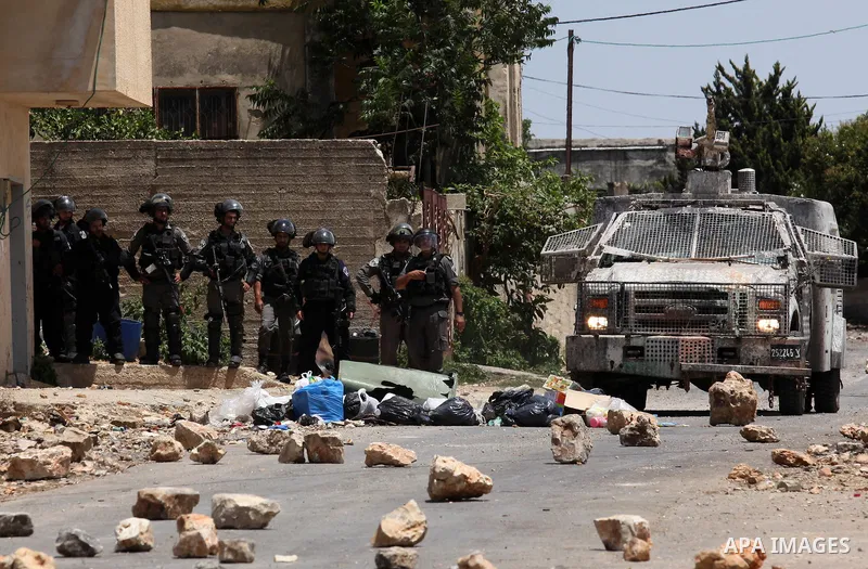 Israeli security forces aim at Palestinian protesters during clashes following a demonstration against the expropriation of Palestinian land by Israel, on June 10, 2016. in the village of Kfar Qaddum, near Nablus, in the...