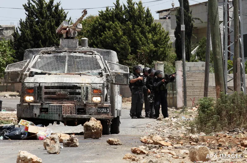 Israeli security forces aim at Palestinian protesters during clashes following a demonstration against the expropriation of Palestinian land by Israel, on June 10, 2016. in the village of Kfar Qaddum, near Nablus, in the...