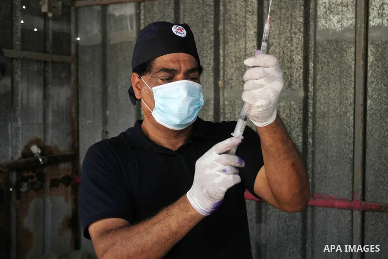 Veterinarian Amir Khalil from the international animal protecting organization Four Paws checks a monkey from a zoo in the southern Gaza Strip city of Khan Younis, June 10, 2016. Photo by Abed Rahim Khatib