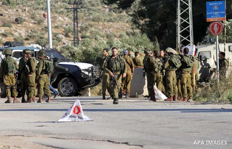 Israeli security forces stand at a checkpoint near the West Bank city of Nablus, June 10, 2016, after a Palestinian man attempted a stabbing attack. Palestinian was shot and wounded, army said. Photo by Nedal Eshtayah