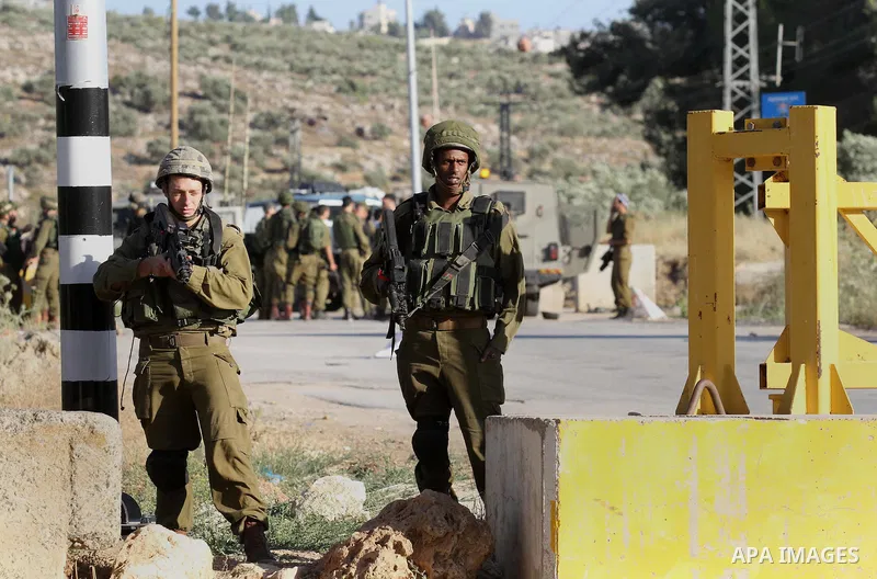 Israeli security forces stand at a checkpoint near the West Bank city of Nablus, June 10, 2016, after a Palestinian man attempted a stabbing attack. Palestinian was shot and wounded, army said. Photo by Nedal Eshtayah