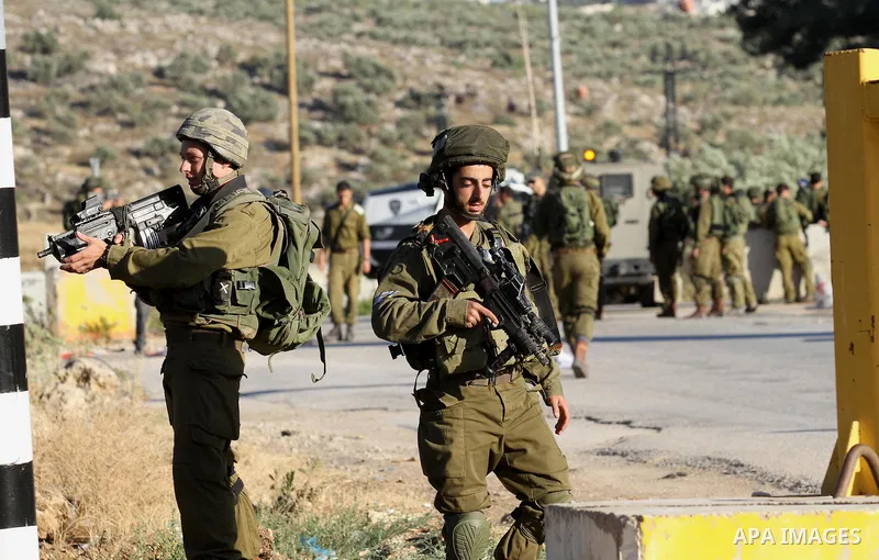 Israeli security forces stand at a checkpoint near the West Bank city of Nablus, June 10, 2016, after a Palestinian man attempted a stabbing attack. Palestinian was shot and wounded, army said. Photo by Nedal Eshtayah