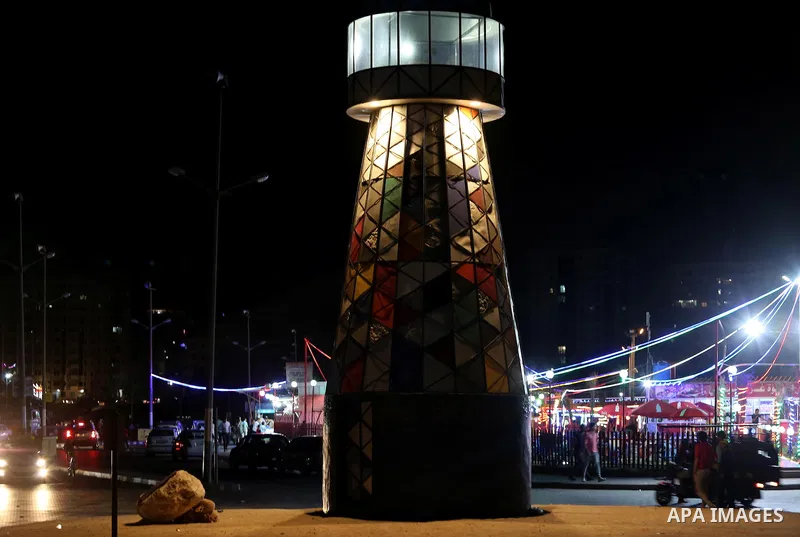 Palestinians walk around the lighthouse at the seaport of Gaza city, on June 10, 2016. Gaza lighthouse project depends on the recycling remnants of Israeli offensive on the Gaza Strip in 2014, for the Palestinian artist...