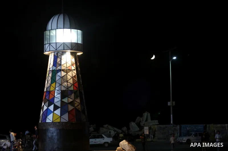 Palestinians walk around the lighthouse at the seaport of Gaza city, on June 10, 2016. Gaza lighthouse project depends on the recycling remnants of Israeli offensive on the Gaza Strip in 2014, for the Palestinian artist...