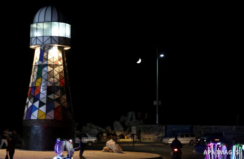 Palestinians walk around the lighthouse at the seaport of Gaza city, on June 10, 2016. Gaza lighthouse project depends on the recycling remnants of Israeli offensive on the Gaza Strip in 2014, for the Palestinian artist...