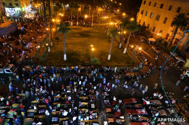 Egyptian Muslims eat their Iftar meal as they break their fast around the garden of Al-Hussein mosque during the holy fasting month of Ramadan, in the old Islamic area of Cairo, Egypt, on June 10, 2016. Ramadan is sacred...