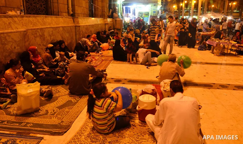 Egyptian Muslims eat their Iftar meal as they break their fast around the garden of Al-Hussein mosque during the holy fasting month of Ramadan, in the old Islamic area of Cairo, Egypt, on June 10, 2016. Ramadan is sacred...