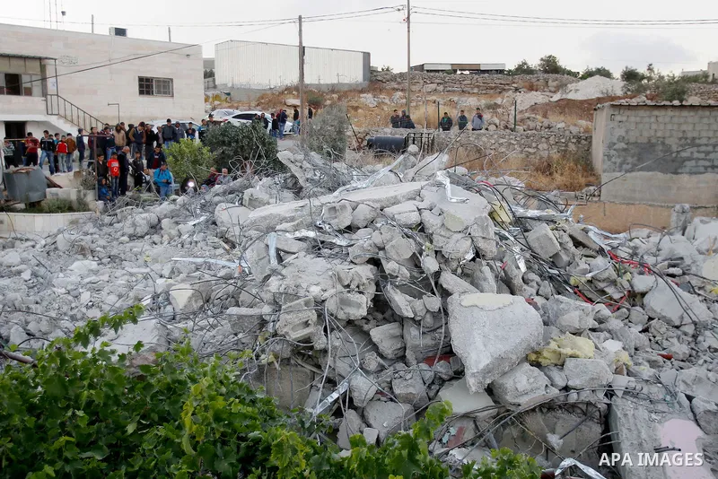 Palestinians look at the rubble of Palestinian teenager Murad Idais house who was accused of stabbing to death a 38-year old Israeli nurse in an attack in the Israeli Otniel settlement in January 2016 after it was demoli...
