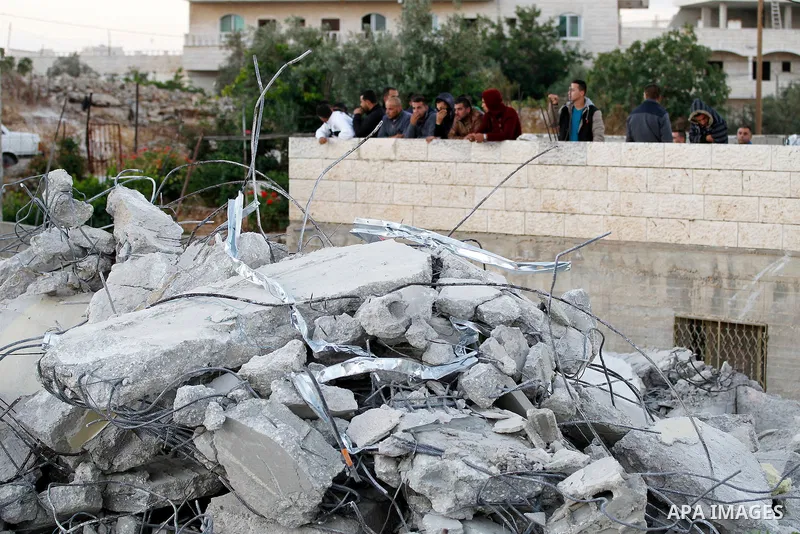 Palestinians look at the rubble of Palestinian teenager Murad Idais house who was accused of stabbing to death a 38-year old Israeli nurse in an attack in the Israeli Otniel settlement in January 2016 after it was demoli...