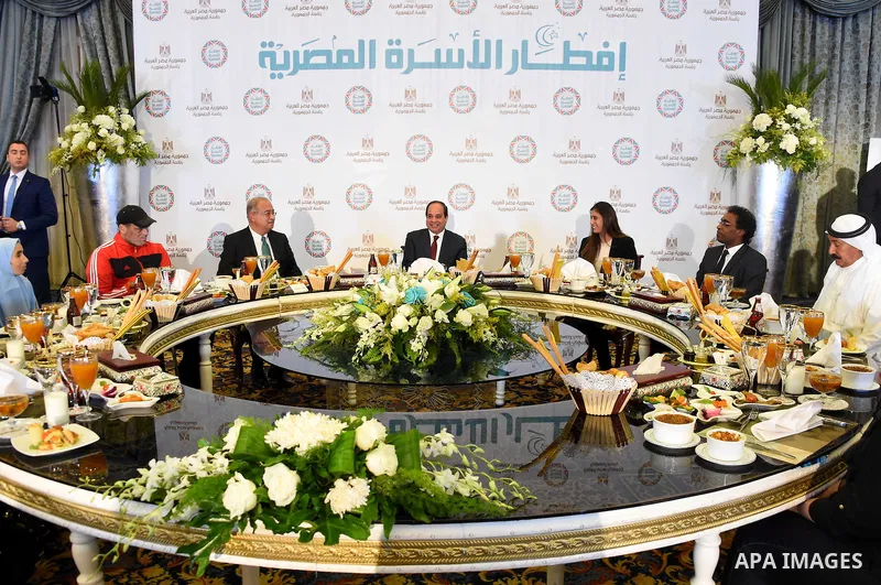 Egyptian President Abdel-Fattah al-Sisi takes part in the Egyptian family breakfast, as he celebrates the Muslim holy month of Ramadan, in Cairo, on June 11, 2016. Photo by Egyptian President Office