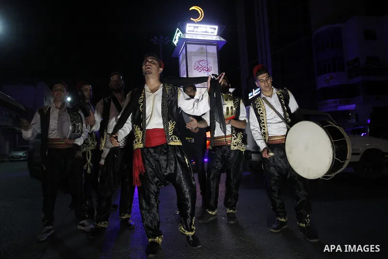 Palestinians dawn awakener "al-Musaharati" walk through streets to wake up Muslims for a meal before sunrise during the fasting month of Ramadan, in the West Bank city of Hebron city on June 12, 2016. Al-Musaharati is an...