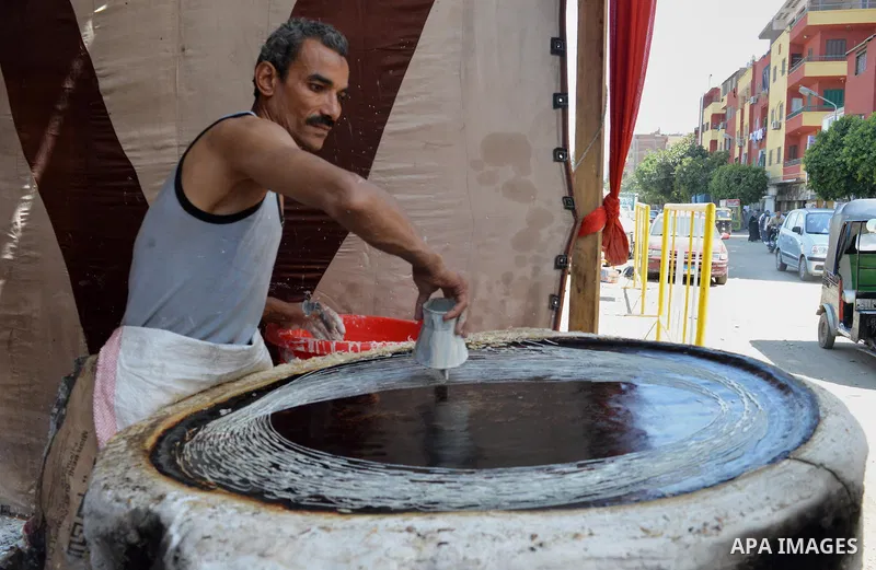 An Egyptian man prepares a traditional sweets "Konafa" on the holy month of Ramadan, in Cairo, Egypt, on June 12, 2016. Ramadan is sacred to Muslims because it is during that month that tradition says the Koran was revea...