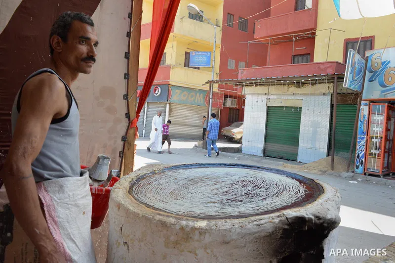 An Egyptian man prepares a traditional sweets "Konafa" on the holy month of Ramadan, in Cairo, Egypt, on June 12, 2016. Ramadan is sacred to Muslims because it is during that month that tradition says the Koran was revea...