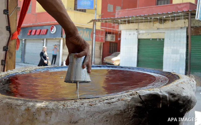 An Egyptian man prepares a traditional sweets "Konafa" on the holy month of Ramadan, in Cairo, Egypt, on June 12, 2016. Ramadan is sacred to Muslims because it is during that month that tradition says the Koran was revea...