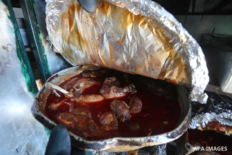 Palestinians prepare rice and meats as they wait for customers several hours before Iftar, the breaking of the day long Ramadan fast in Gaza City, on June 12, 2016. Muslims around the world refrain from eating, drinking...
