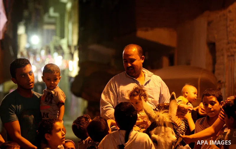 An Egyptian dawn awakener "al-Musaharati" ride a donkey through streets to wake up Muslims for a meal before sunrise during the fasting month of Ramadan, in Cairo, Egypt, on June 13, 2016. Al-Musaharati is an old profess...