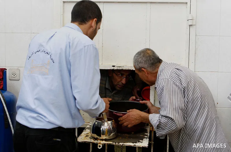 Palestinians prepare food to be distributed for free during the holy fasting month of Ramadan in the West Bank city of Hebron, 13 June 2016. the "Ibrahimi Takiya" was founded in 960 AD as an institute provides food for o...